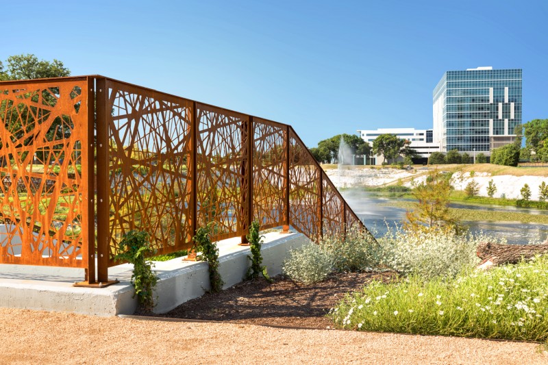 Close up of Revamp Nest Pattern Standard Corten Railing with Tall Building in Background